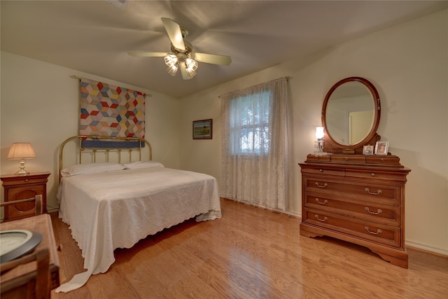 bedroom with light hardwood / wood-style floors and ceiling fan