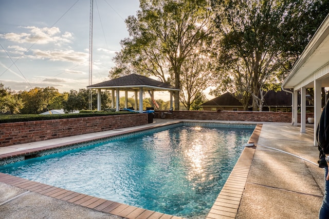 view of swimming pool featuring a gazebo and a patio area