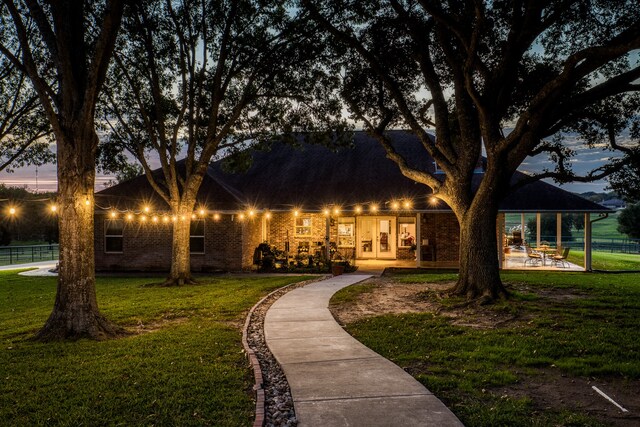 view of front facade featuring french doors and a lawn