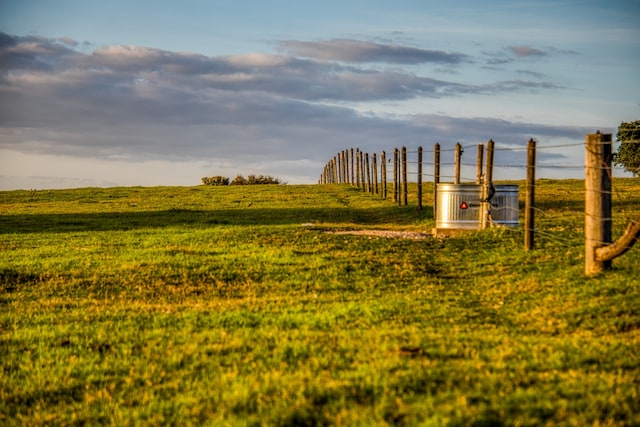 view of yard with central air condition unit and a rural view