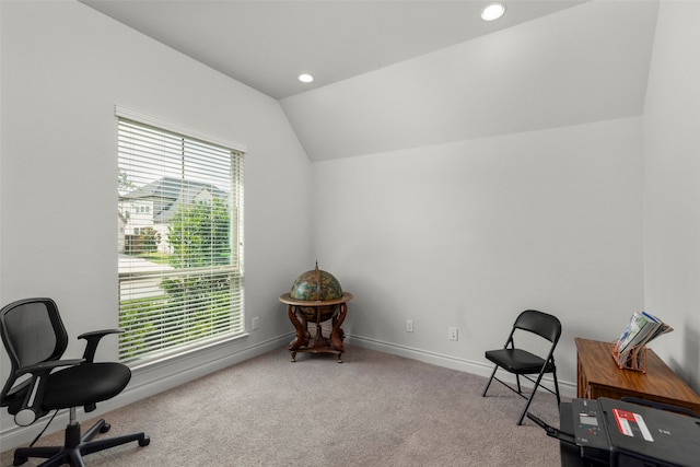 carpeted home office with lofted ceiling