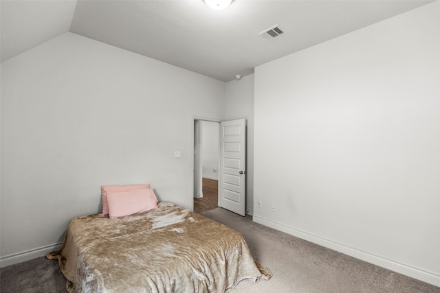 carpeted bedroom with vaulted ceiling