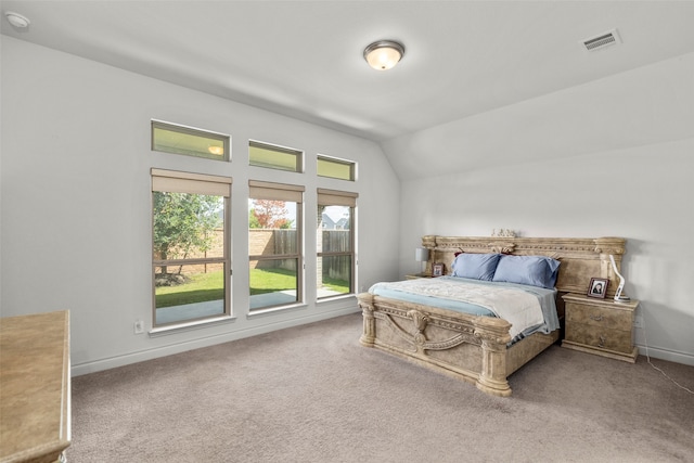 carpeted bedroom with lofted ceiling