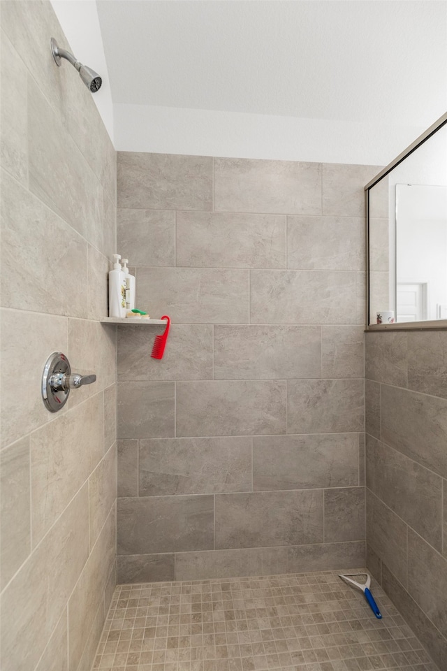 bathroom with a tile shower