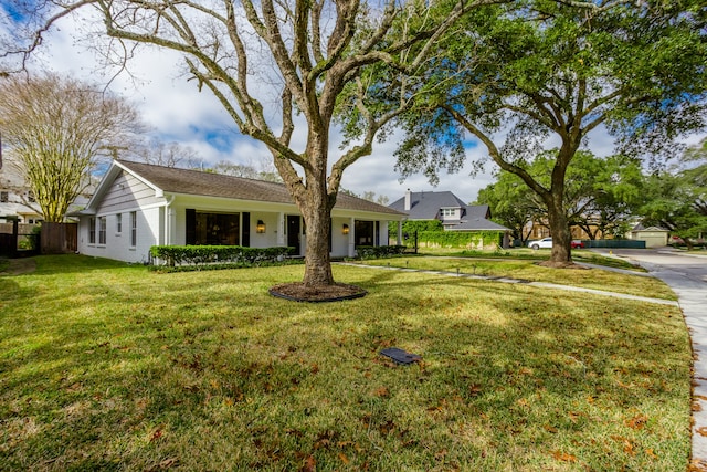 single story home featuring a garage and a front yard