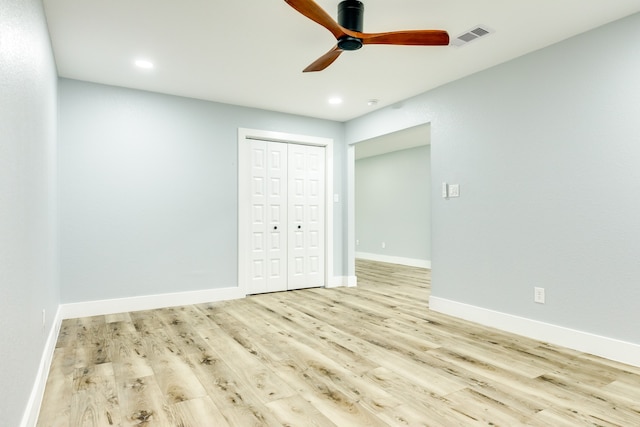 unfurnished bedroom featuring light hardwood / wood-style flooring, a closet, and ceiling fan