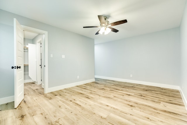 unfurnished room with ceiling fan and light wood-type flooring