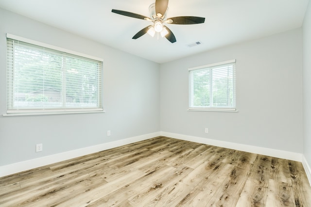 empty room with light wood-type flooring and ceiling fan