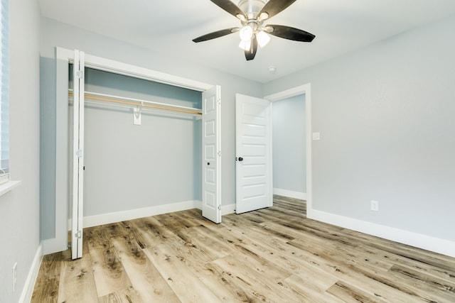 unfurnished bedroom with light wood-type flooring, ceiling fan, and a closet