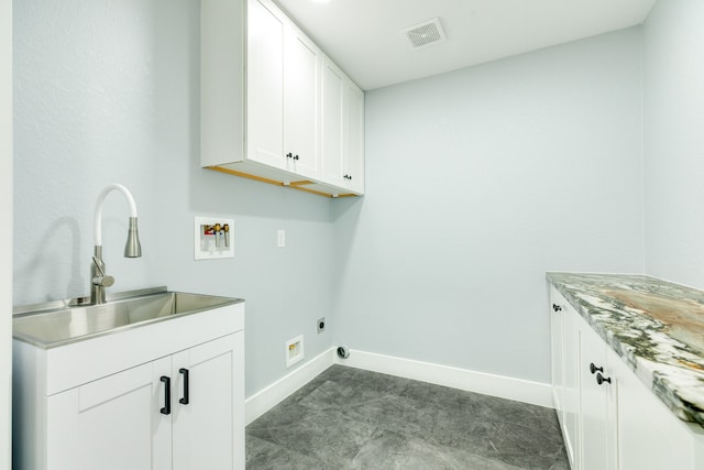 laundry room featuring dark tile patterned floors, sink, cabinets, electric dryer hookup, and washer hookup