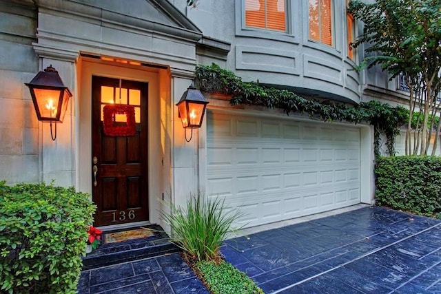 doorway to property with a garage