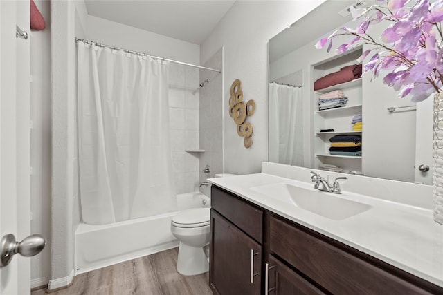 full bathroom featuring shower / tub combo, hardwood / wood-style flooring, toilet, and vanity