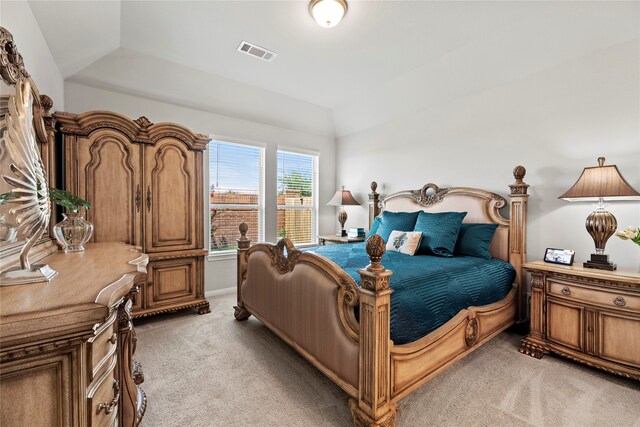 carpeted bedroom with lofted ceiling