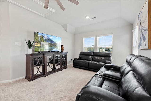 carpeted living room with ceiling fan and vaulted ceiling