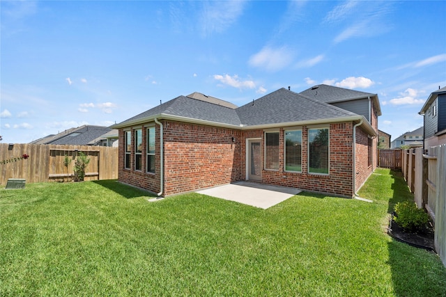 back of house featuring a yard and a patio area