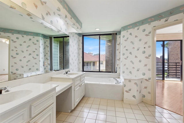 bathroom with vanity, a bath, and tile patterned floors