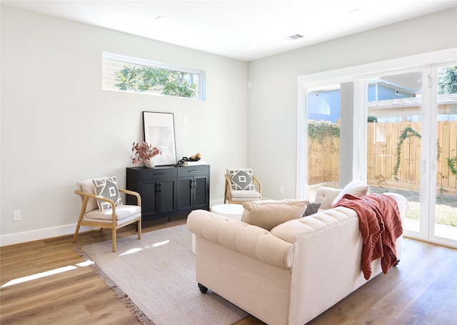 living area with hardwood / wood-style floors and plenty of natural light