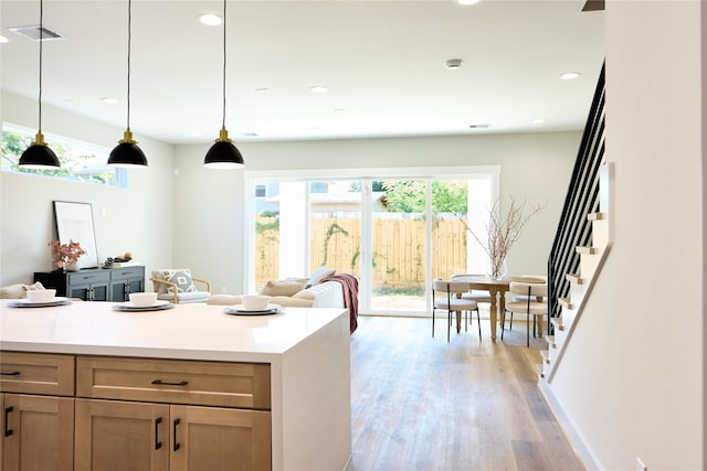 kitchen with light hardwood / wood-style floors and decorative light fixtures