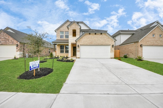 view of property with a front yard and a garage