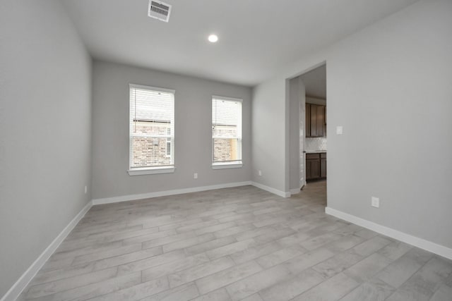 unfurnished room with light hardwood / wood-style flooring