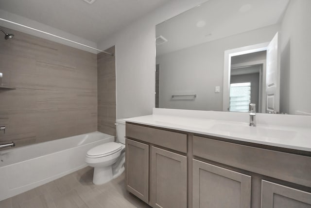 full bathroom featuring vanity, toilet, and tiled shower / bath