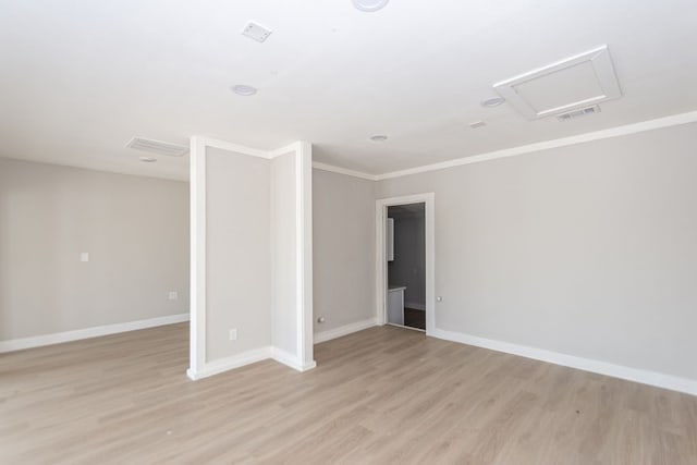 spare room with crown molding and light hardwood / wood-style floors