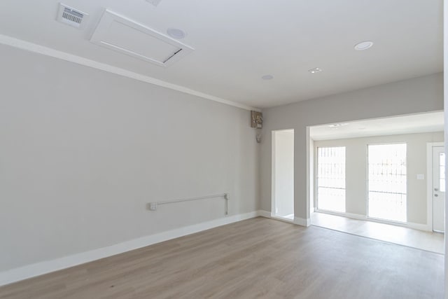 spare room with light hardwood / wood-style floors