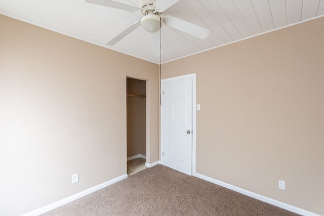 unfurnished bedroom with carpet, ceiling fan, and a closet