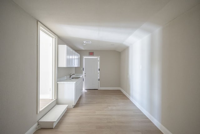 hall featuring sink and light hardwood / wood-style floors