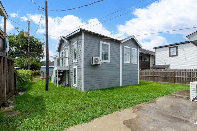 rear view of house with ac unit, a lawn, a patio, and a deck