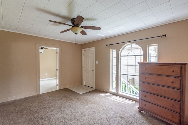 tiled spare room with ceiling fan