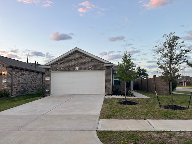 view of front of property with a lawn and a garage