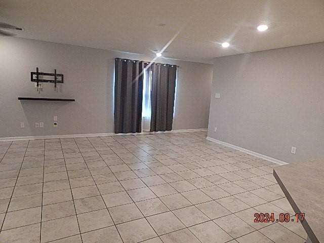 spare room with light tile patterned floors