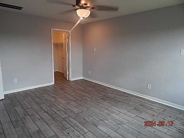 spare room featuring light hardwood / wood-style floors and ceiling fan