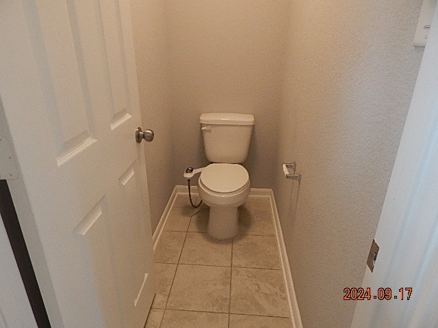 bathroom featuring tile patterned flooring and toilet