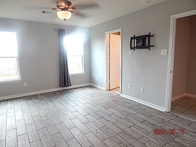 spare room featuring light hardwood / wood-style floors and ceiling fan