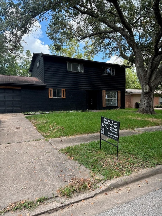 view of front property with a garage and a front lawn