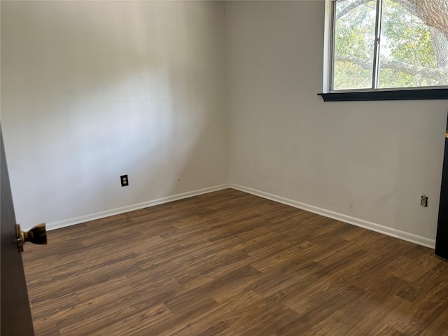 empty room featuring dark wood-type flooring