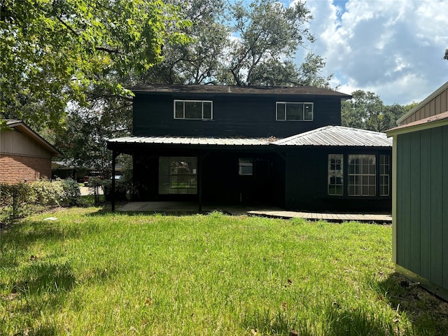 back of property featuring a yard