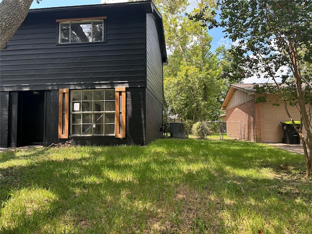 exterior space featuring a yard and cooling unit