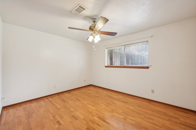 empty room featuring light hardwood / wood-style floors, a textured ceiling, and ceiling fan