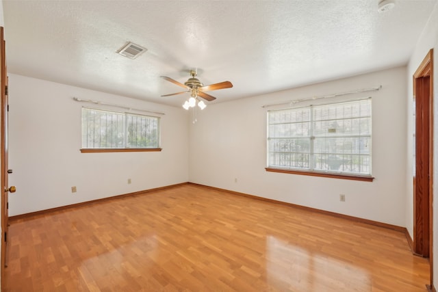 empty room with light hardwood / wood-style flooring, a textured ceiling, and ceiling fan