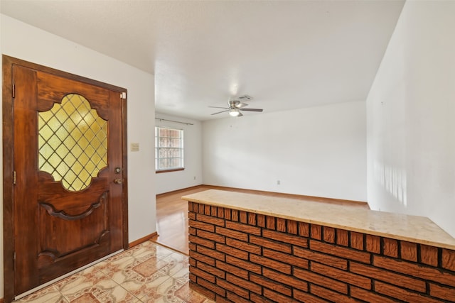 entrance foyer with ceiling fan