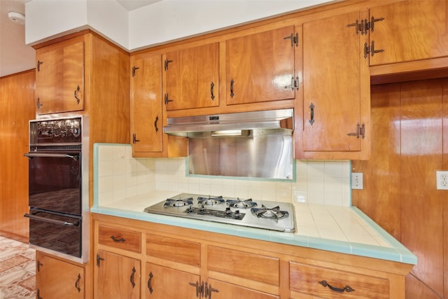 kitchen featuring decorative backsplash and white gas stovetop