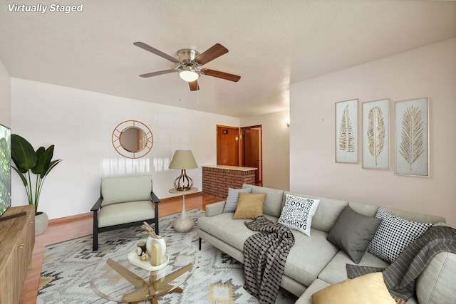 living room featuring light hardwood / wood-style floors and ceiling fan