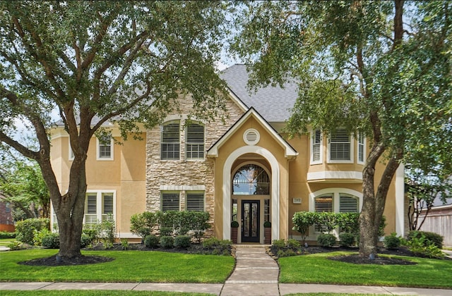 view of front of property featuring french doors and a front yard