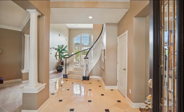 entrance foyer featuring ornate columns, crown molding, and light hardwood / wood-style flooring