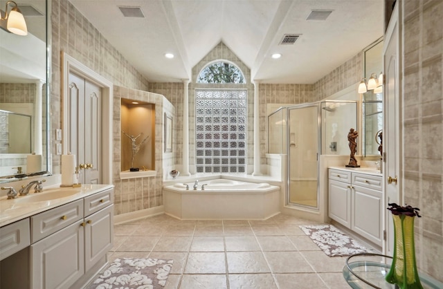 bathroom featuring vanity, lofted ceiling, independent shower and bath, and tile patterned flooring