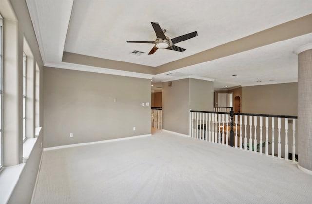 unfurnished room with crown molding, light carpet, and ceiling fan