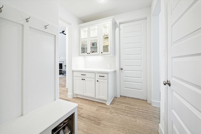 mudroom with light hardwood / wood-style floors